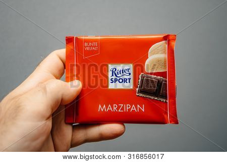 Paris, France - Apr 27, 2019: Man Hand Holding Delicious Ritter Sport Chocolate With Marzipan Taste 