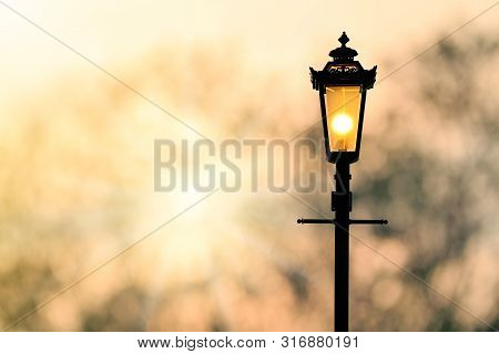 A Classic Style Of Lantern With Sunset Background (sillhouette)