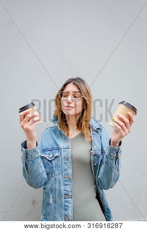 Blonde Girl With Paper Cups Of Coffee On Grey