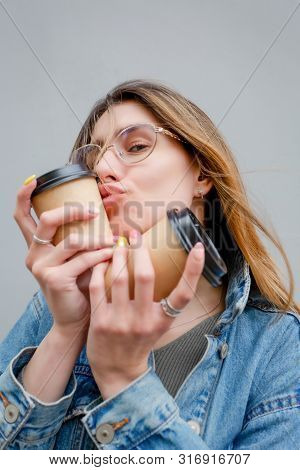 Blonde Girl With Paper Cups Of Coffee On Grey