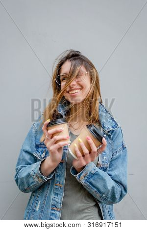 Blonde Girl With Paper Cups Of Coffee On Grey