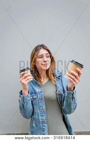 Blonde Girl With Paper Cups Of Coffee On Grey
