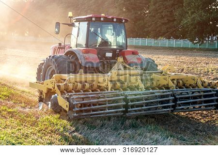 Tractor Cultivator Plows The Land, Prepares For Crops. Dust On Field