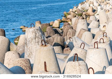 Breakwaters In Sea. Beautiful Sunset Seascape With Concrete Tetrapodes For Protect Coastal Structure