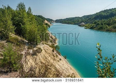 Panorama Of Chalkpit On Limestone Coast Of Huge Turquoise Lake Or River Near Forest. Chalk Quarry Fi