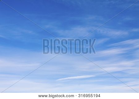 Dense Blue Clouds In Twiling Sky In Winter Evening.
