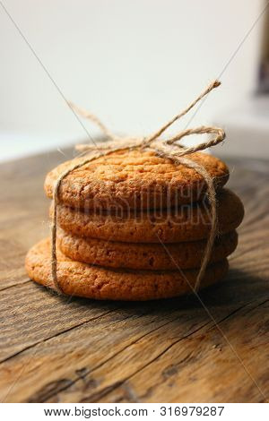 Homemade Oatmeal Cookies On An Old Wooden Table, Rustic Style. Oatmeal And Cinnamon Sticks. Copy Spa