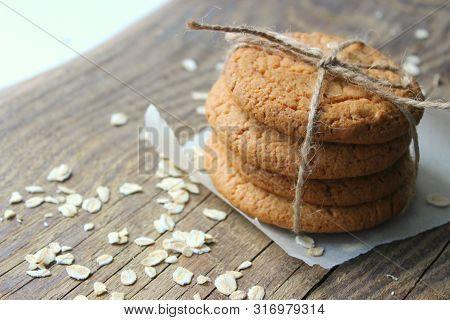 Homemade Oatmeal Cookies On An Old Wooden Table, Rustic Style. Oatmeal And Cinnamon Sticks. Copy Spa