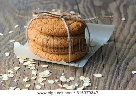 Homemade Oatmeal Cookies On An Old Wooden Table, Rustic Style. Oatmeal And Cinnamon Sticks. Copy Spa