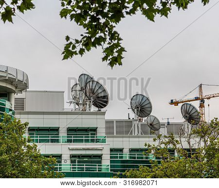 Many Satellite Dishes On Rooftop Of A Communicaitons Building