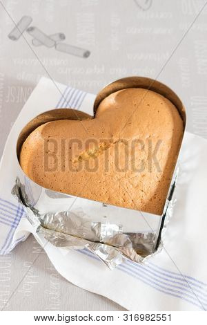 Sponge Cake In Metal Form On A White Towel, Light Background