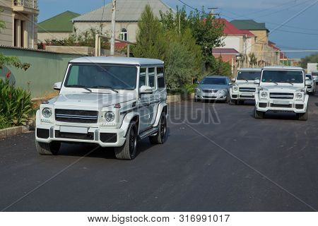 Wedding Cortege In The Baku City Centre. Wedding Cortege At The Head Of The Car. Red And White Flowe