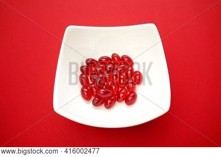 Krill Oil Gelatin Capsules Close-up.omega Fatty Acids.natural Supplements And Vitamins.red Capsules 
