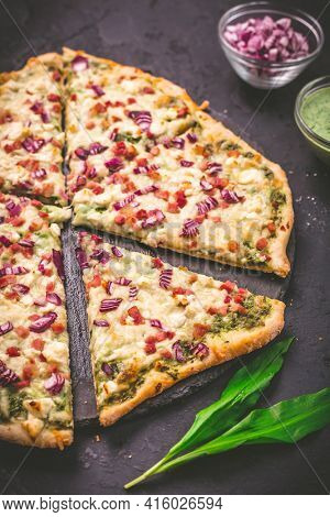 Tart flambee (Flammkuchen) with ramson sour cream (bear leek), onion and bacon