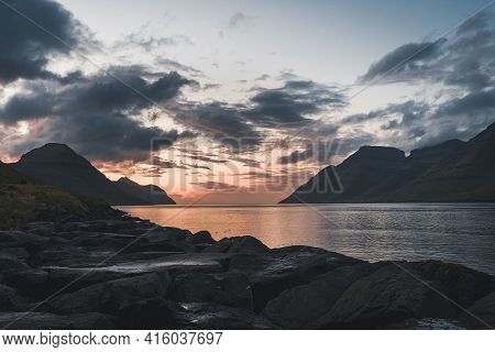 Faroe Islands Kalsoy In Sunset Light Durig Twilight With Pink Sky And Cliffs.