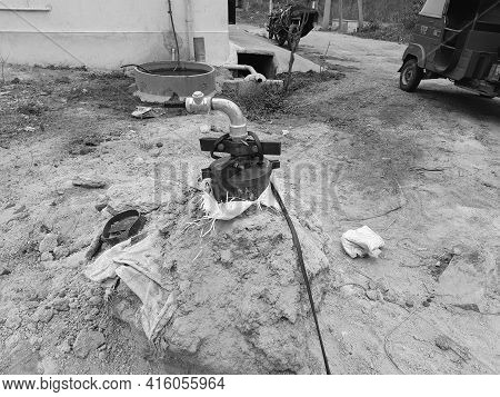 Closeup Of Exterior View Of Bore Well Outside Metal Pipe In A Empty Field For Water Flow