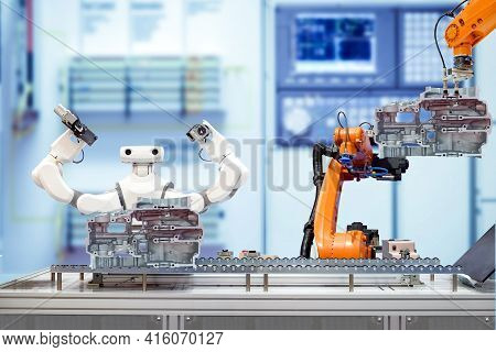 Industrial Robotic Teamwork Working With Engine Parts Of Motorbike Via Conveyor On Blurred Smart Fac