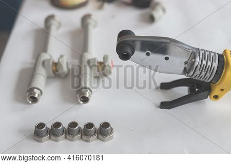 Soldering Iron For Polypropylene With Polypropylene Pipe With Tap On White Table