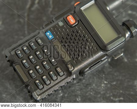 Compact But Powerful Walkie-talkie In Black With A Display On A Dark Background. Close-up
