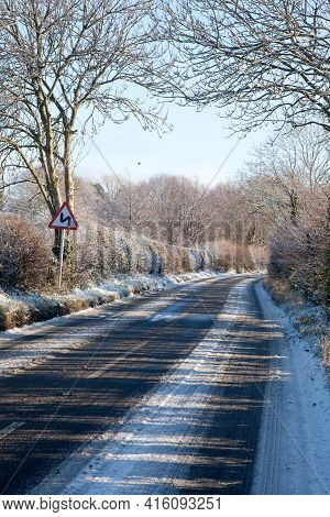 A Country Lane In The Snow On A Sunny Day