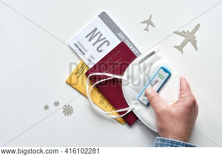 New Normal Travel During Covid-19 Restrictions, Flat Lay On White Background. Hand Hold German Passp