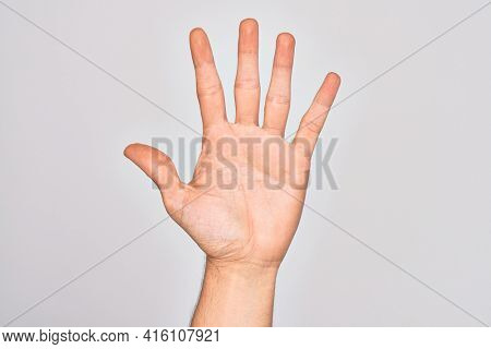 Hand of caucasian young man showing fingers over isolated white background counting number 5 showing five fingers