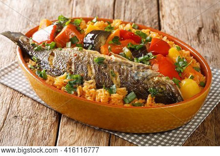 Senegalese Rice And Fish With Vegetables Thieboudienne Closeup In The Dish On The Table. Horizontal