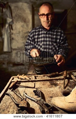 cobbler at work with old tools