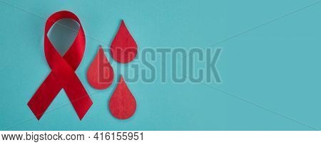 Awareness Oncept With Blood Drop And Red Ribbon. World Hamophilia Day Or Blood Donor Day