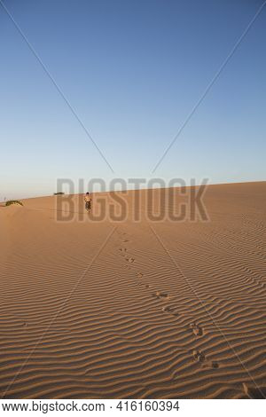 La Guajira, Colombia, January16: Man Walking In Sand Dunes. View Of The Colombian Coastline In La Gu