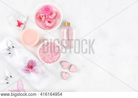 Spa And Wellness Composition With Aromatic Rose Water, Salt, Roses And Sakura, Towels, Aromatherapy 