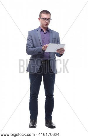 Full lenth portrait of cool businessman using electronic tablet