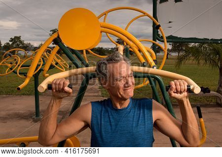 Senior Man Working Out At An Outdoor Fitness Park In Parque Das Garças, Brasilia