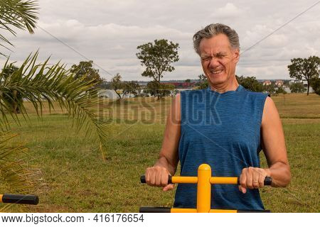 Senior Man Working Out At An Outdoor Fitness Park In Parque Das Garças, Brasilia