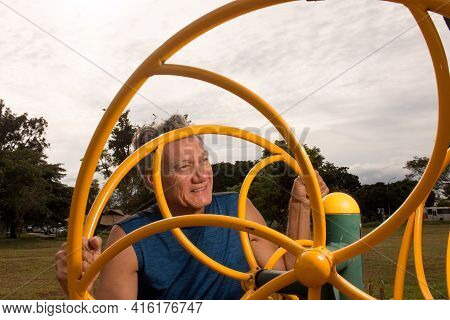 Senior Man Working Out At An Outdoor Fitness Park In Parque Das Garças, Brasilia