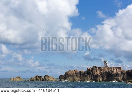 Lighthouse On The Rocky North Coast Of The Island Of Brehat, Brittany, France
