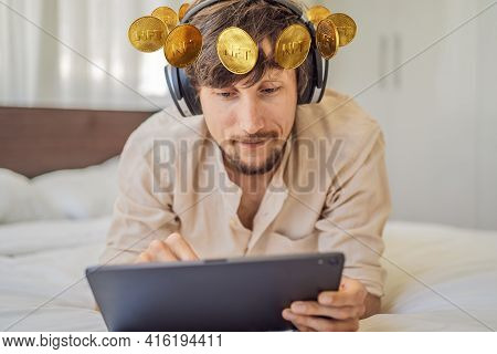 Young Man, A Digital Artist, Dj Creates Digital Art On A Tablet At Home And Shows A Coin With The In