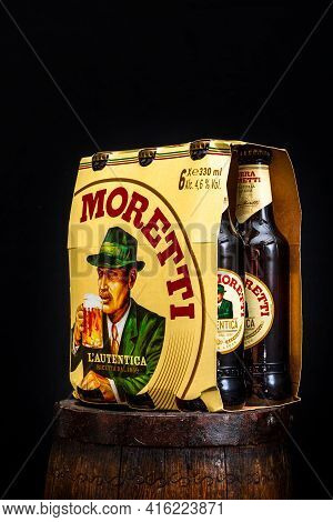 6 Pack Of Birra Moretti Beer On Wooden Barrel With Dark Background. Illustrative Editorial Photo Buc