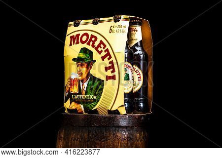 6 Pack Of Birra Moretti Beer On Wooden Barrel With Dark Background. Illustrative Editorial Photo Buc