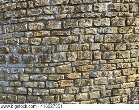 Horizontal part of Old yellow brick wall with devastating bricks, Belgian Ardennes, Belgium, Torgny 
