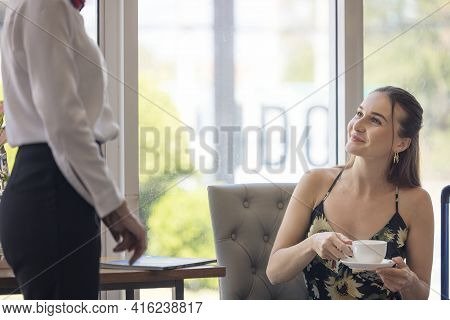 Tourist Woman Going To Fill And Sign Hotel Check In Registration Form At Reception Counter, Kundense