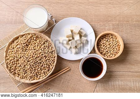 Soybean Seeds And Product (tofu, Soy Milk, Soy Sauce) On Wooden Table, Healthy Vegan Food