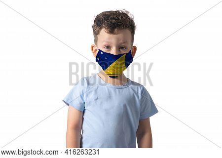 Respirator With Flag Of Tokelau. White Boy Puts On Medical Face Mask Isolated On White Background.