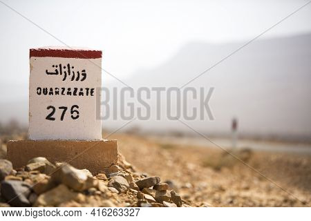 Ouarzazate 276 Kilometres - Road Sign Distance Indicator On The Road To Ouarzazate With Blurred Back