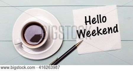 On A Light Blue Wooden Tray, There Is A White Cup Of Coffee, A Handle And A Napkin That Says Hello W