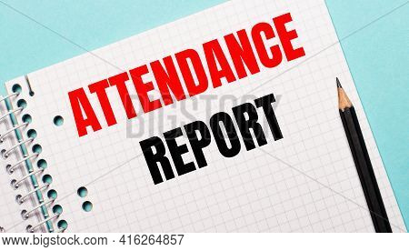 On A Light Blue Background, A Checkered Notebook With The Words Attendance Report And A Black Pencil