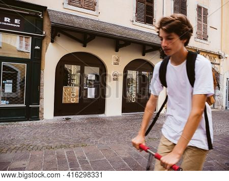 Chambery, France - Aug 15, 2017: Defocused Silhouette Of French Boy On Electric Scooter Discovering 