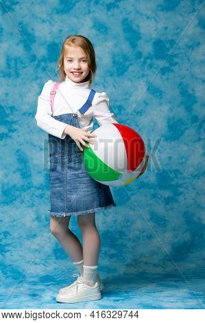 Little Girl Is Playing With A Ball.the Concept Of Childrens Sports, Summer Outdoor Recreation.