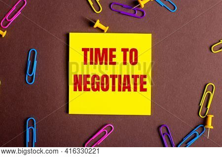 The Words Timr To Negotiate Is Written In Red On A Yellow Sticker On A Brown Background Next To Mult
