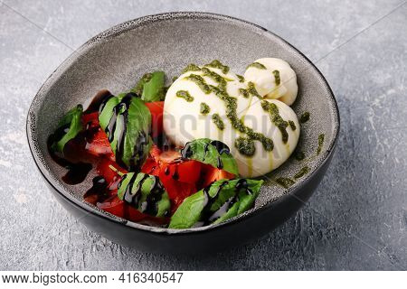 Buratta. Salad With Buratta, Pesto, Basil, Tomatoes And Balsamic. Caprese Salad With Buratta